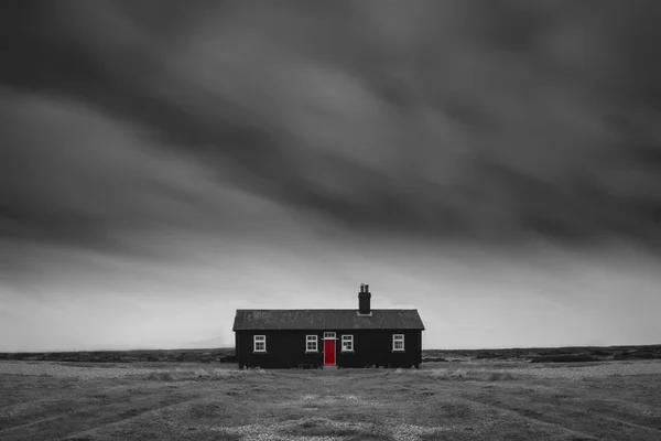 Remote desolate isolated house under dark stormy sky during Wint — Stock Photo, Image