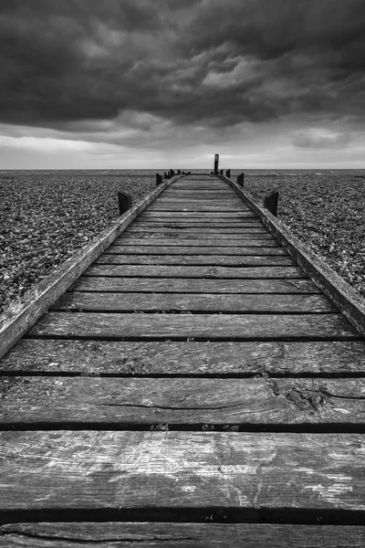 Concept image of path to nowhere in desolate beach black and whi — Stock Photo, Image