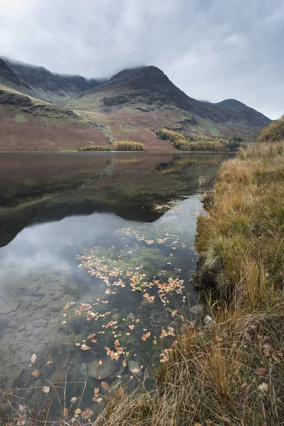 Stuning Autumn Fall landscape image of Lake Buttermere in Lake D