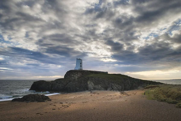 Stunning Twr Mawr lighthouse landscape from beach with dramatic — Stock Photo, Image