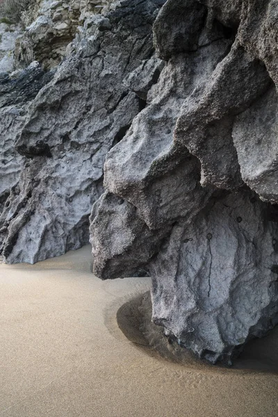 Intimate landscape image of rocks and sand on Broadhaven beach i — Stock Photo, Image