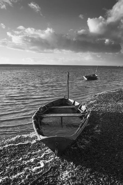 Beautiful black and white sunset landscape image of boats moored — Stock Photo, Image