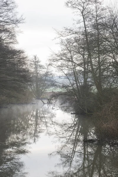 Low hanging misty morning landscape over calm stream in English — Stock Photo, Image