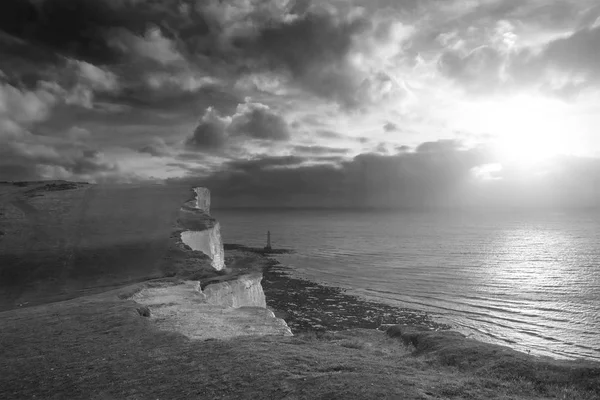 Stunning black and white landscape image of Beachy Headt lightho