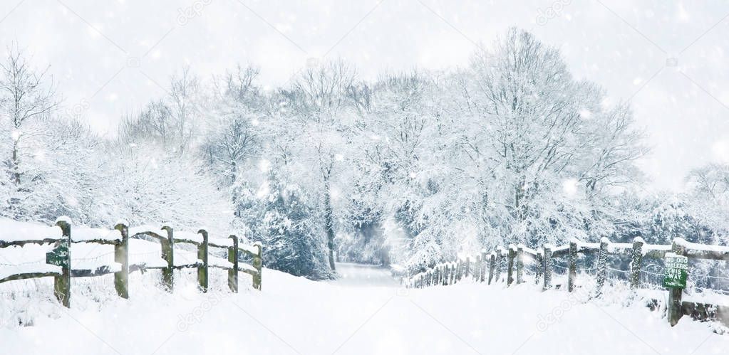 Path through English rurual countryside in Winter with snow in h