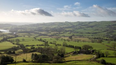 Beautiful Peak District Winter landscape of late afternoon sun a
