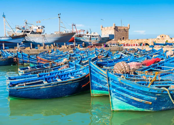 Porto de Essaouira com barcos de pesca azul e forte no fundo em Marrocos — Fotografia de Stock