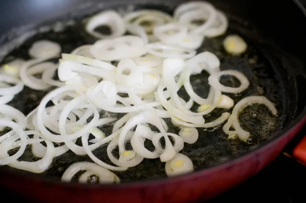 Onion is frying on pan red color — Stock Photo, Image