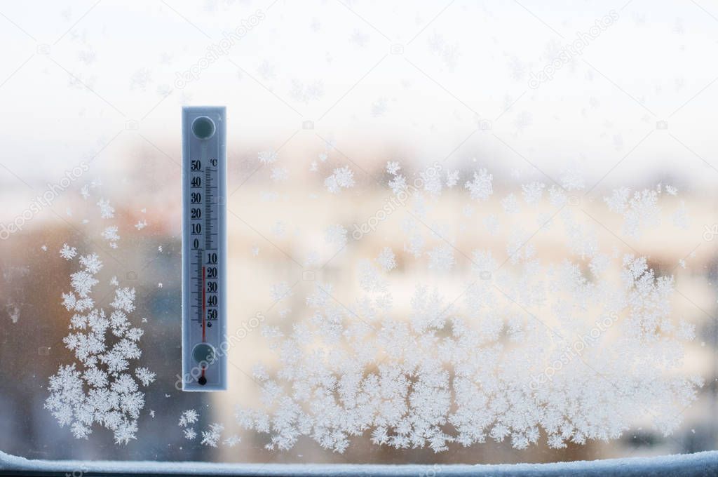 thermometer on winter window with frosts