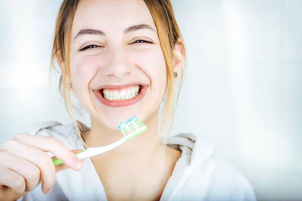 Feliz jovem mulher escovando dentes . — Fotografia de Stock