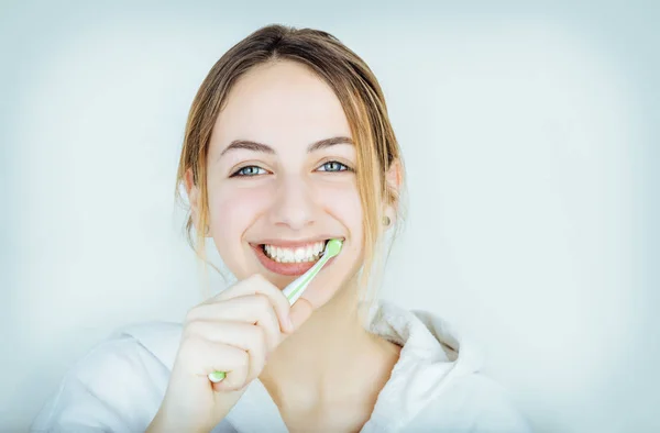 Feliz joven mujer cepillarse los dientes . — Foto de Stock