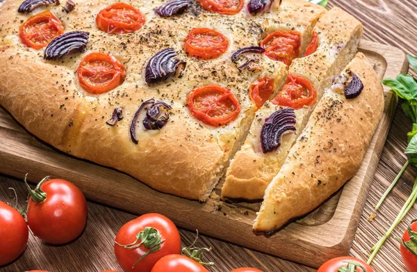 Focaccia with caramelized onion and tomato . Bread. — Stock Photo, Image