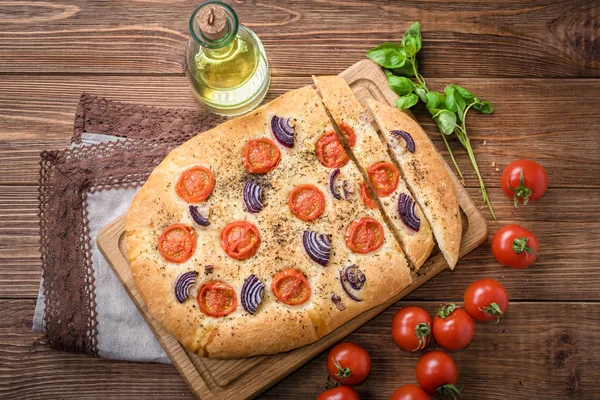 Focaccia with caramelized onion and tomato . Bread. — Stock Photo, Image