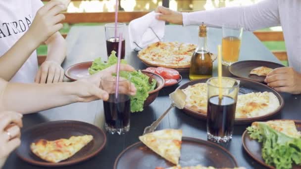 Gruppe junger Freunde genießt eine Mahlzeit, isst Pizza. — Stockvideo