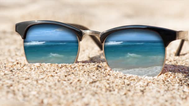 Cinemagraph - Sunglasses on the sand. Motion Photo. — Stock Video