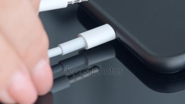 Close up of a mobile phone connected to a charger. — Stock Video