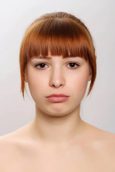 Close-up studio portrait of a young beautiful woman demonstratin Stock Image