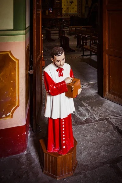 Acolyte with donation box for gifts in church Royalty Free Stock Images