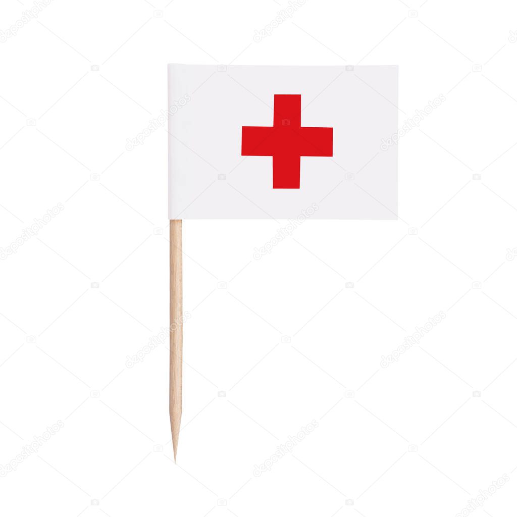 Red Cross Miniature paper flag. Isolated toothpick flag pointer on white background.