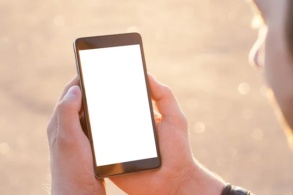 Man uses his Mobile Phone outdoor, close up