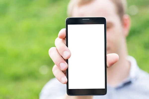 Young man showing a mobile phone application — Stock Photo, Image