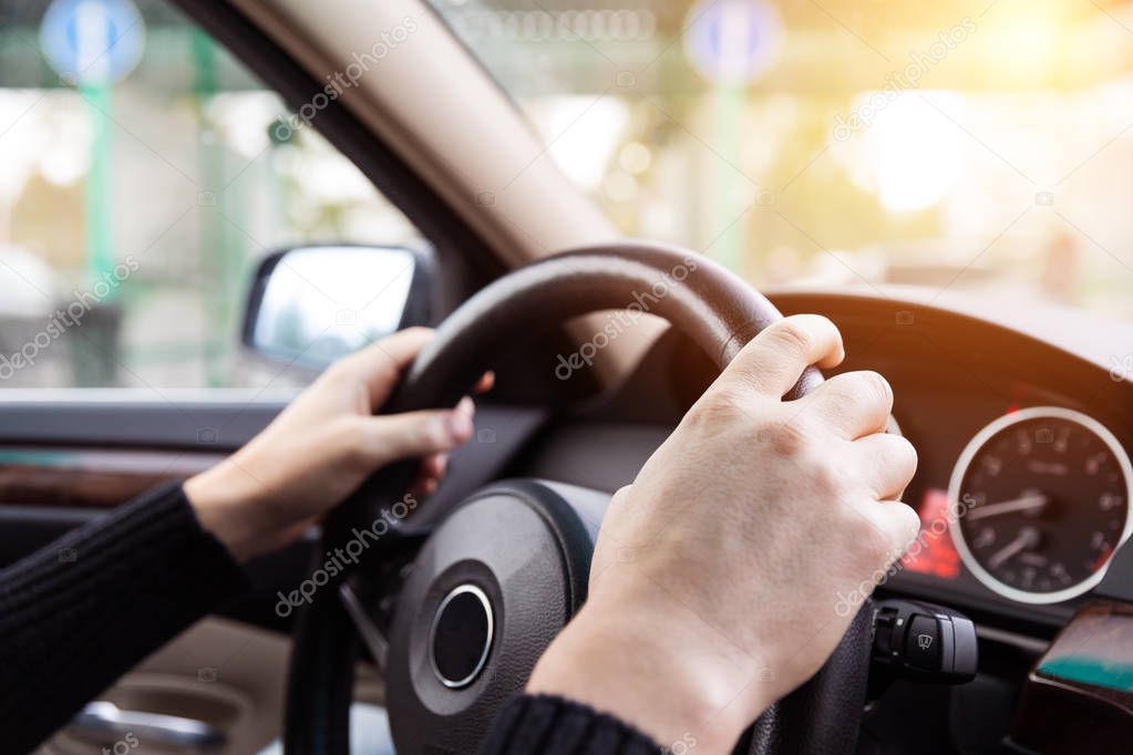 Close up of man hands driving a car during sunlight. Vintage fil