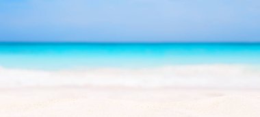 Bulanık mavi gökyüzü ve beyaz kumlu deniz manzarası. Tropik plaj manzarası. Yaz tatili kavramı.