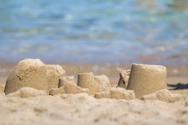 A sandcastle on a sandy beach