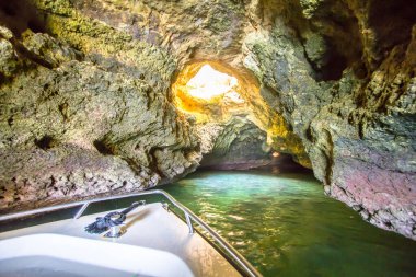 Boat tour inside of the grotto in Ponta de Piedade, Portugal