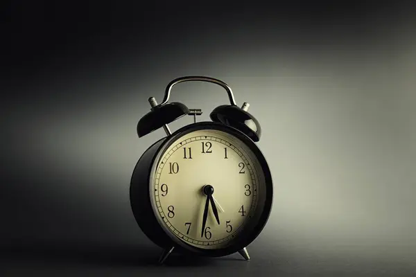 Винтажные часы на изолированном темном фоне — стоковое фото