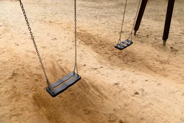 Some swings in the schoolyard closeup photo — Stock Photo, Image