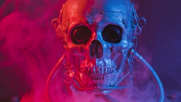 Crâne robotique en lumière rouge et bleue avec fumée — Video
