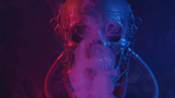 Robotic skull in red and blue light with smoke — Stockvideo