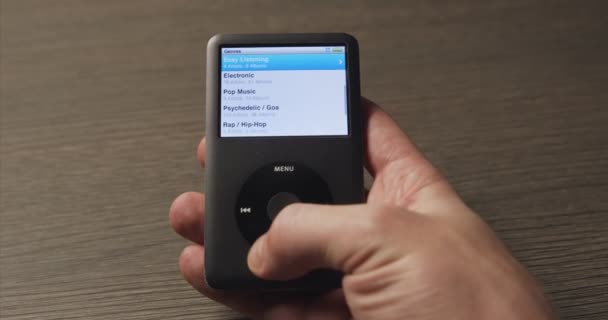 Browsing genres in old music player closeup footage — Stock Video