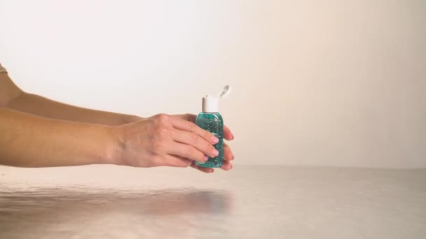 Girl washes hands with disinfection antiseptic white background — Stock Video