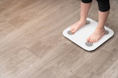 Bebeklerin bacaklarının ölçülü olarak dikey yakın plan fotoğrafı. Çocukluk obezite kontrol konsepti, yan görüş.