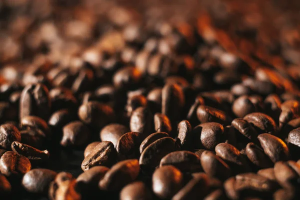 roasted coffee beans, can be used as background. Coffee production concept for coffee shop. Grains after roasting on a dark background
