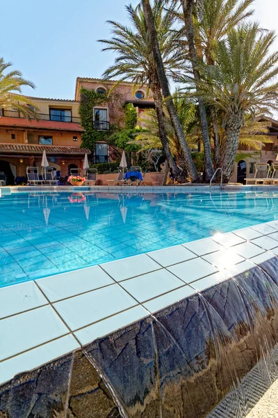 Low angle view of a never-ending swimming pool in a sunny day - Holiday, Travel Destination - Arbatax, Sardinia, Italy - 18th of May 2019