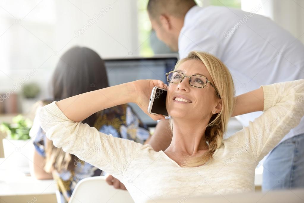 woman in office talking on phone