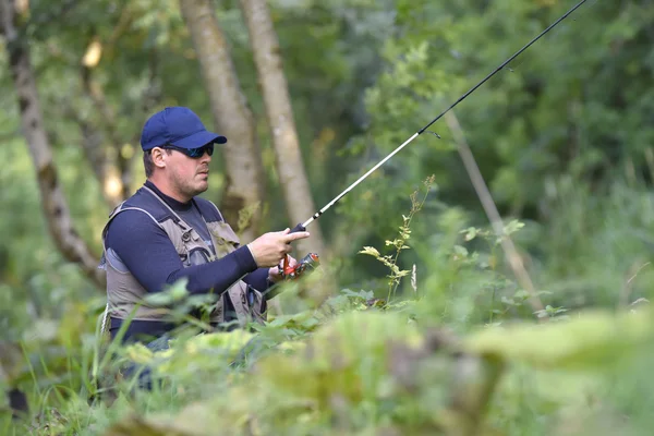 Fisherman fishing  from riverbanks — Stock Photo, Image