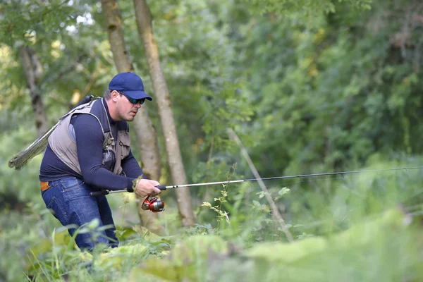 Fisherman fishing  from riverbanks — Stock Photo, Image