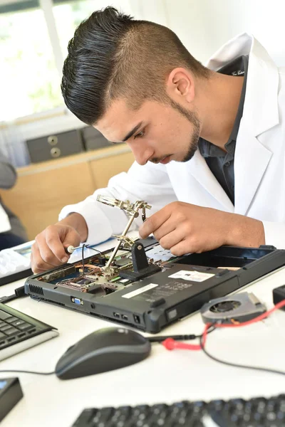Student  fixing computer processing