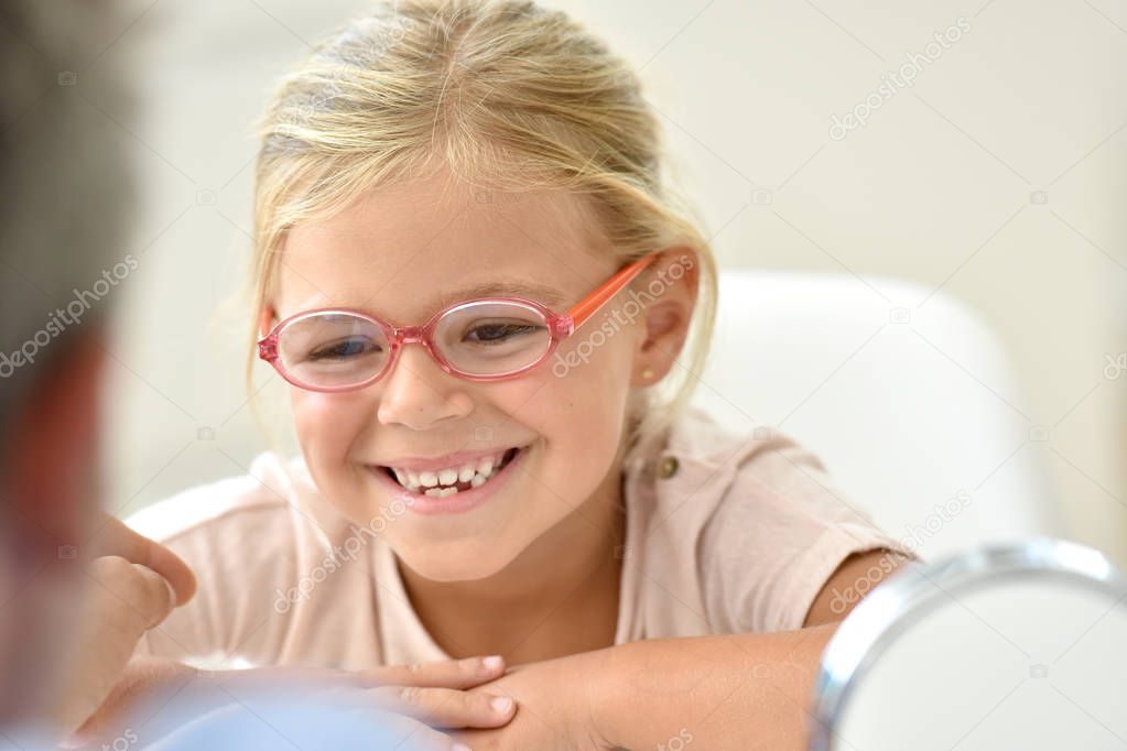 girl at the optician trying eyeglasses 