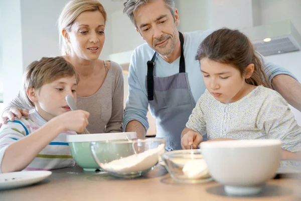 Ouders met kinderen bakken taart — Stockfoto