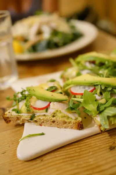 Bread slice with avocado and radish — Stock Photo, Image