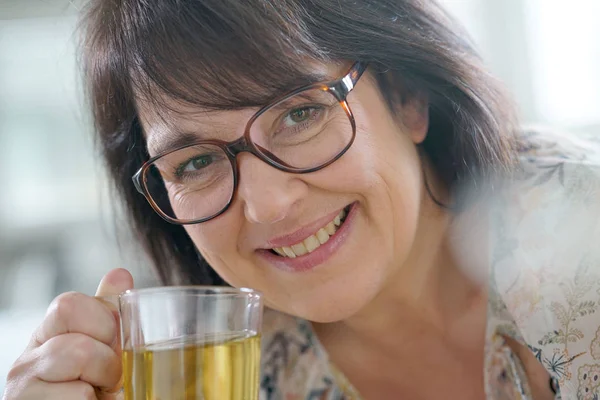 woman with eyeglasses drinking