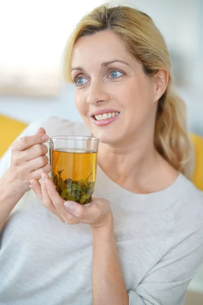 Woman drinking plants infusion — Stock Photo, Image