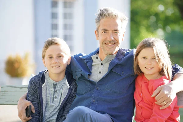 Portrait of father with kids sitting o — Stock Photo, Image