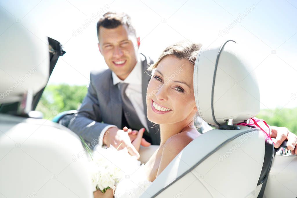 bride sitting in convertible car
