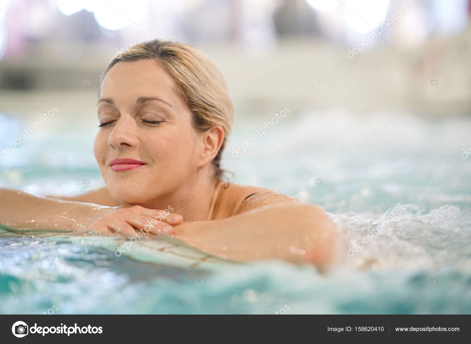 Woman enjoying thermal bath Stock Photo by ©Goodluz 158620410